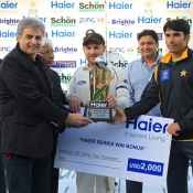 Misbah-ul-Haq and Brendon McCullum receive the winning bonus and trophy