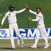 Zulfiqar Babar and Shan Masood celebrate the wicket of Tom Latham