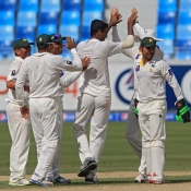 Ehsan Adil celebrates the wicket of Brendon McCullum with his team-mates