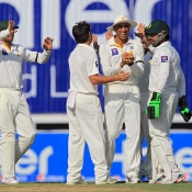 Yasir Shah and Younis khan celebrate the wicket of Ross Taylor