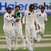 Sarfraz Ahmed, Yasir Shah and Shan Masood celebrate the wicket of Ross Taylor
