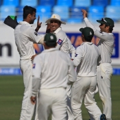 Ehsan Adil celebrates the wicket of Corey Anderson with his team-mates