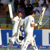 Younis Khan and Misbah-ul-Haq going off he field after their centuries