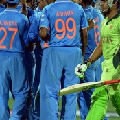 Indian teammates celebrate the wicket of Umar Akmal