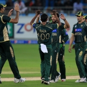 Raza Hasan celelbrates the wicket of Corey Anderson with his teammates
