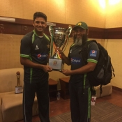 Azhar Ali and Mushtaq Ahmed pose with the Trophy