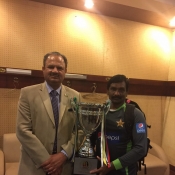 Team Pakistan Manager Naveed Akram Cheema & Masseur Malang Ali pose with the Trophy