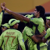 Mohammad Irfan and team-mates celebrate the wicket of Chibhabha