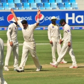 Imran Khan celebrates the wicket of Chris Rogers on the final day of the 1st Test at Dubai