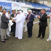 Senior Journalist Qamar Ahmed receiving his award from Moin Khan for covering his 400th Test match