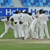 Pakistan team celebrate the wicket of Mitchell Johnson on the final day of the 1st Test at Dubai