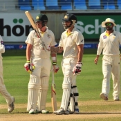 Mitchell Johnson celebrates his fifty on the final day of the 1st Test at Dubai