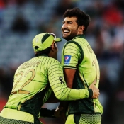 Sohail Khan and Misbah-ul-Haq celebrate the vital wicket of AB de Villiers